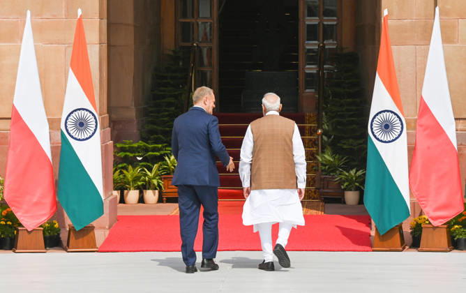 NEW DELHI, INDIA - OCTOBER 22: Prime Minister Narendra Modi (R) welcomes Prime Minister of Poland, Donald Tusk (L), prior to their delegation-level bilateral meeting and joint press statement at Hyderabad House on October 22, 2026 in New Delhi, India. The high-level meeting marked Polish Prime Minister Tusk s official visit to India from October 21-23, 2026 his first visit to the country as Prime Minister since 2010 aimed at advancing the India-Poland Strategic Partnership and deepening India-EU strategic ties. During wide-ranging discussions, both leaders reviewed bilateral cooperation across key sectors including trade, technology, defense-industrial collaboration, and energy, while reaffirming joint commitment toward peaceful diplomatic