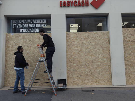 Lyon France Anti-Government Protest Men install wooden panels over the windows of a secondhand goods shop in Lyon, France, on October 24, 2026. Businesses in central Lyon took precautions amid concerns about further unrest following damage to shops during demonstrations the previous weekend. Lyon Rhone Alpes France Copyright: xAbolfazlxSalmanzadehx