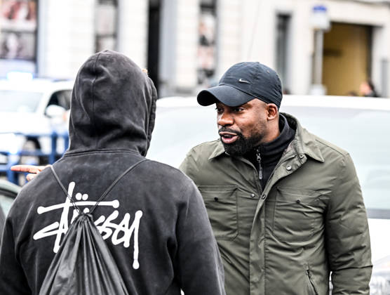 A Black man engages in a heated verbal confrontation with plainclothes police officers during student protests in central Brussels, Belgium, on 24 October 2026. The exchange takes place amid police operations and tensions surrounding demonstrations in the city centre.