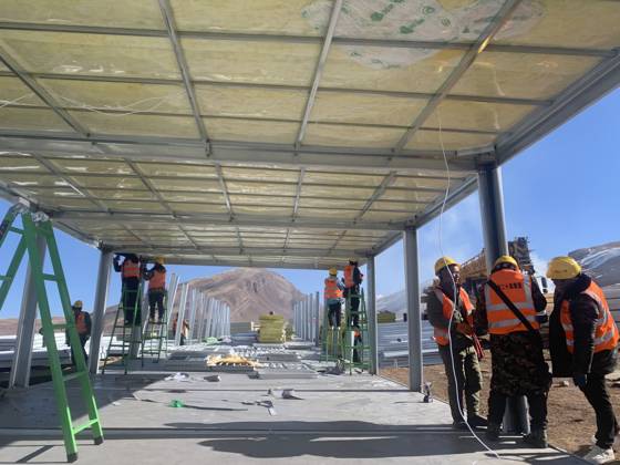 (261025) -- BAQEN, Oct. 25, 2026 () -- Rescuers from the China Railway 20th Bureau Group Corporation Limited build prefabricated houses at a quake-hit village in Gangchen Township of Baqen County, Nagqu City, southwest China s Xizang Autonomous Region, Oct. 25, 2026. Rescue and relief efforts continue after a 7.0-magnitude earthquake struck Baqen County of the city of Nagqu in southwest China s Xizang Autonomous Region, local authorities said Saturday. The roof panels of the first batch of prefabricated houses have been installed in Sunday afternoon in the quake-hit village in Gangchen Township of Baqen, and the laying of cables and the installation of doors and windows have been advanced successively. Currently, seven prefabricated houses 